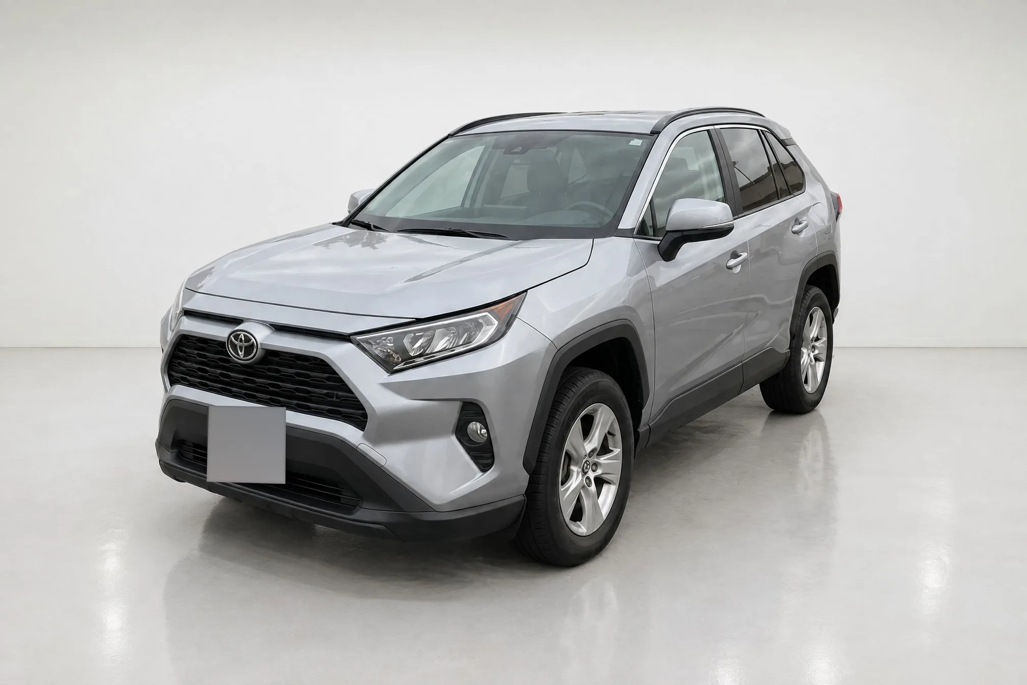 The same RAV4 from the lot photo, finished in the white studio